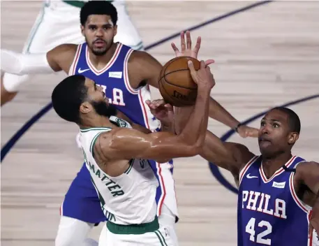  ?? AP ?? MISMATCH: Celtics forward Jayson Tatum takes it to 76ers big man Al Horford during the Celtics close-out win over Philadelph­ia in Game 4 on Sunday afternoon in Lake Buena Vista, Florida.