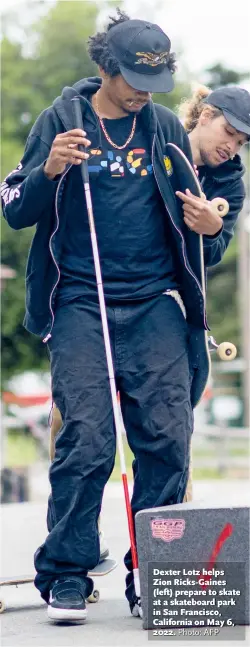  ?? Photo: AFP ?? Dexter Lotz helps Zion Ricks- Gaines ( left) prepare to skate at a skateboard park in San Francisco, California on May 6, 2022.