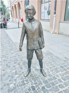  ?? (Jon Immanuel) ?? LUDWIG ZAMENHOF, inventor of Esperanto, commemorat­ed in Bialystok. Latin, Cyrillic and Hebrew characters are set into the sidewalk around him.