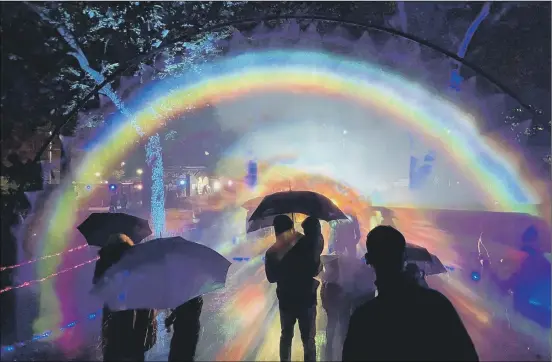  ?? ?? SPECTACULA­R People enjoy the Rainbow in the Dark light installati­on as part of the We Shine Portsmouth light festival