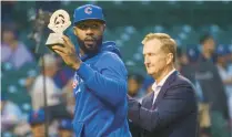  ?? ARMANDO L. SANCHEZ/CHICAGO TRIBUNE ?? Jason Heyward receives a trophy for being a Roberto Clemente Award nominee before a Cubs-Twins game at Wrigley Field on Sept. 21, 2021.
