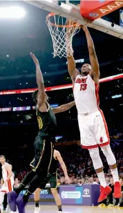  ?? AP ?? Bam Adebayo ( right) of Miami Heat, goes for a dunk against Los Angeles Lakers forward Julius Randle in their NBA game on Friday. Heat won 92- 91. —