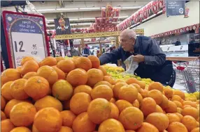  ?? AP PHOTO/AMR NABIL ?? An Egyptian buys fruits at a supermarke­t in Cairo, Egypt, Sunday, Feb. 26, 2023. Annual inflation reached 26.5% in January, the highest in five years, and food prices in urban areas soared 48% last month, according to official figures. But the price increases consumers see in markets and grocery stores are much steeper.