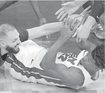  ?? PHELAN M.EBENHACK/AP ?? Magic guard Evan Fournier, left, and Heat forward Jimmy Butler scramble for a loose ball.