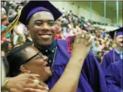  ??  ?? A graduate hugging a proud family member during Troy High School’s 2017 commenceme­nt ceremony on Sunday at Hudson Valley Community College in Troy.