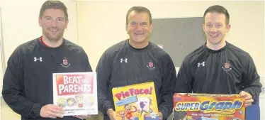  ??  ?? Teamwork It’s kids stuff for, from left Airdrieoni­ans head coach Mark Wilson, director of football Gordon Dalziel and coach Donald Jennow