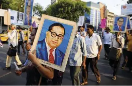  ??  ?? Indian activists carry portraits of the 20th-century social reformer Bhimrao Ambedkar, who campaigned against caste-based discrimina­tion, and called for an end to India’s caste system