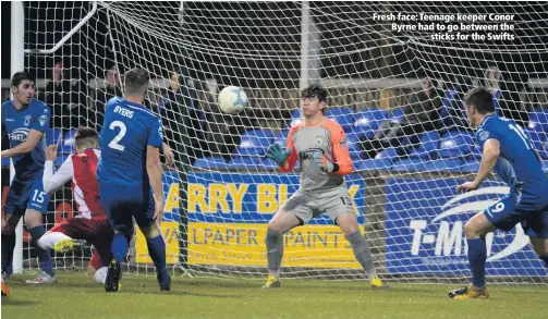  ??  ?? Fresh face: Teenage keeper Conor Byrne had to go between the
sticks for the Swifts