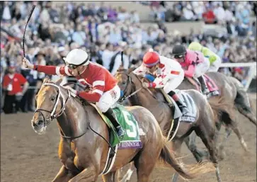  ?? Gregory Bull Associated Press ?? FLORENT GEROUX rides Gun Runner to victory in the Breeders’ Cup Classic at Del Mar last November. Gun Runner, the Eclipse Award winner for horse of the year, is the 4-5 favorite for the Pegasus World Cup.