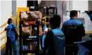  ?? Photograph: Patrick T Fallon/AFP/Getty Images ?? An Amazon delivery driver pushes a cart of groceries to load into a vehicle outside of a distributi­on facility on 2 February 2021 in Redondo Beach, California