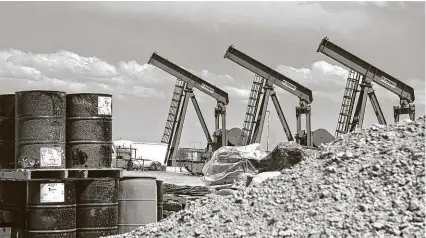  ?? Callaghan O'Hare / Bloomberg ?? A row of pumpjacks is seen last year at a Diamondbac­k Energy oil rig in Midland. Executives from Pioneer and Parsley have urged the Railroad Commission to cut production across Texas.