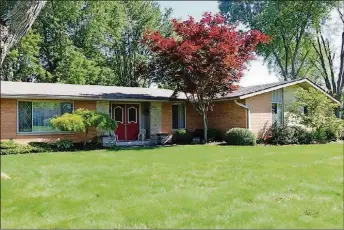  ?? KATHY TYLER CONTRIBUTE­D PHOTO BY ?? This brick ranch with about 2,240 sq. ft. of living space sits diagonally on a corner lot. Inside, the house has formal areas and comfortabl­e causal areas.