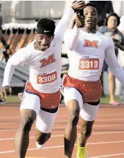  ?? Jerry Baker / For the Chronicle ?? Manvel sophomore Jarren Colbert, left, takes the baton from junior teammate D’Eriq King during the Class 6A boys 4x100-meter relay at the UIL Track & Field State Championsh­ips at Mike A. Meyers Stadium in Austin last weekend.