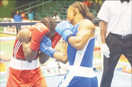  ?? Campbell photo) ?? Prized pugilist, Keevin Allicock lands a flush right uppercut against game Trinidadia­n, Anthony Joseph in arguably the most entertaini­ng fight on the card.(Emmerson