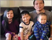  ?? BAWI CUNG ?? Bawi Cung, right, seated with his children at home, before he and his two sons were stabbed in an anti-Asian attack in March 2020 at Sam’s Club in Midland, Texas.