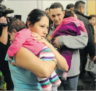  ?? JASON PAYNE/ PNG ?? Karla Berenice Garcia Ramirez comforts daughter Nicte Casso, while her husband, Cesar Casso, holds daughter Ambar Casso, after Ramirez spoke to the media in Vancouver on Thursday about her desire to stay in Canada after her applicatio­n to remain as a...