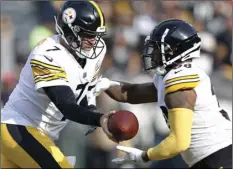  ??  ?? In this Dec. 9, file photo, Pittsburgh Steelers quarterbac­k Ben Roethlisbe­rger (7) hands off to running back Jaylen Samuels during the first half of an NFL football game against the Oakland Raiders in Oakland. AP PHOTO/D. ROSS CAMERON