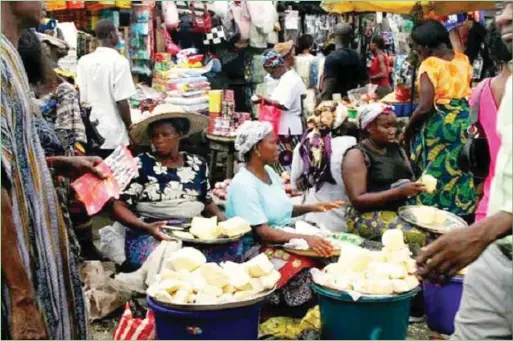  ??  ?? A local market in Nigeria... many families groaning under high cost of essential commoditie­s