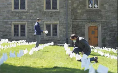  ?? Tyler Sizemore / Hearst Connecticu­t Media file photo ?? The Rev. Patrick Collins, left, and U.S. Rep. Jim Himes, D-4, place flags in memory of the Connecticu­t lives lost from coronaviru­s at First Congregati­onal Church of Greenwich on May 12.