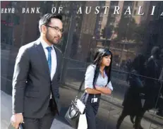  ?? — Reuters ?? People walk past Reserve Bank of Australia in central Sydney.
