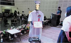  ?? AARON FAVILA THE ASSOCIATED PRESS ?? A student’s picture is seen on a tablet placed on a robot during a “cyber-graduation” ceremony at a school in Manila, Philippine­s, on Friday.
