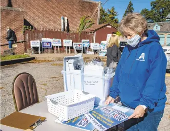  ?? PHOTOS BYAPRILGAM­IZ/THE MORNING CALL ?? Kathy Harrington — the volunteer coordinato­r for Lehigh Valley for All, a grassroots group she helped form after President Donald Trump’s victory in 2016 — prepares an event for residents to pick up candidate signs and literature Saturday in Bethlehem.