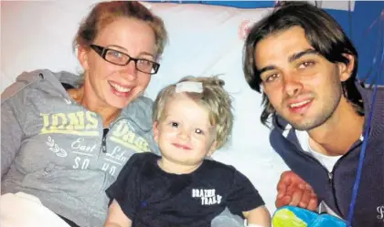  ?? PHOTO: CONTRIBUTE­D ?? UNCERTAIN TIMES: Kirsten Kay and Clinton Rayner with their son, Braxton Rayner, after one of several surgeries the toddler has undergone.