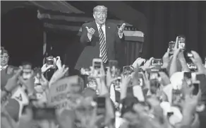  ?? MARIO TAMA/ GETTY IMAGES ?? President Donald Trump gets the crowd going at a campaign rally Friday at the Las Vegas Convention Center.