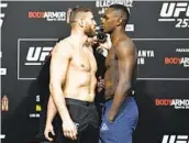  ?? ZUFFA LLC/AP ?? Jan Blachowicz (left) and Israel Adesanya face off during the UFC 259 weigh-in on Friday.