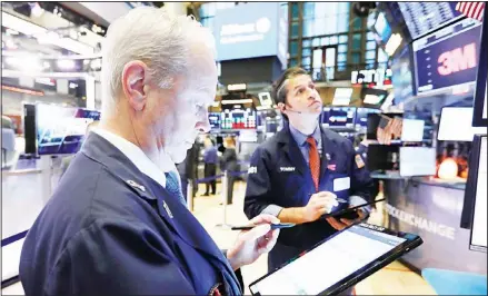  ??  ?? Traders James Riley (left), and Thomas Donato work on the floor of the New York Stock Exchange on Jan 28. US stocks rose broadly in morning trading
on Wednesday as investors focused on solid earnings from several big companies. (AP)