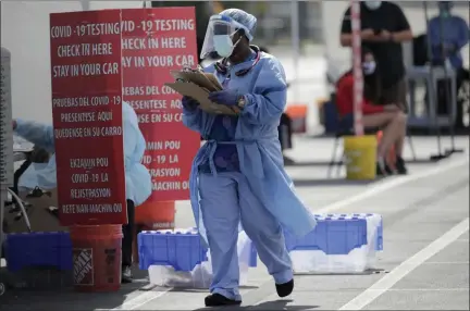  ?? LYNNE SLADKY — ASSOCIATED PRESS ?? A health care worker is shown at a COVID-19 testing site at the Martin Luther King Jr. Clinica Campesina Health Center in Homestead, Fla., on Monday.