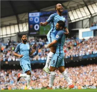  ?? GARETH COPLEY, GETTY IMAGES ?? Manchester City’s Raheem Sterling celebrates scoring the opening goal with Nolito (9) in 3-1 victory.