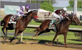  ?? JULIO CORTEZ - THE ASSOCIATED PRESS ?? Mario Gutierrez rides Nyquist, left, past Gun Runner during the 142nd running of the Kentucky Derby at Churchill Downs May 7 in Louisville, Ky.