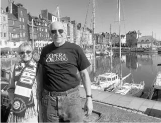  ?? COURTESY OF STEVE SPEISER ?? Orlando residents Steven and Diane Speiser display their Orlando pride at the Vieux-Bassin (Old Port) in Honfleur, Normandy, France, whose atmosphere has inspired painters, writers and musicians for centuries. Have a picture of yourself (or a loved...