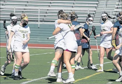  ?? JOHN LOVE / SENTINEL & ENTERPRISE ?? Fitchburg State’s Julia Miele, right, gets hugged by teammate Madison Alves after scoring during Saturday’s game against Salem State.