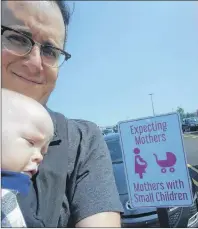  ?? CP PHOTO/JUSTIN SIMARD ?? Justin Simard and his nine-month-old son, Charlie, are seen in this undated handout photo in Stratford. The P.E.I. dad was miffed about a parking spot for new mothers at a P.E.I. grocery store and has successful­ly prodded Sobeys to change its policy so...