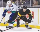  ?? The Associated Press ?? Vancouver Canucks captain Henrik Sedin, left, battles for the puck with Boston Bruins’ Riley Nash (20) during NHL action in Boston on Saturday.The Bruins won 4-3.