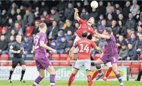  ??  ?? HIGH JUMP: Crewe Alex’s Chris Porter challenges for the ball during the FA Cup match against Carlisle. Below: Crewe’s Harry Pickering in action. Pictures: Steve Finch