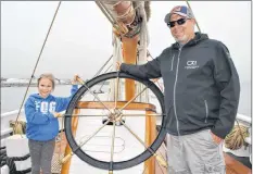  ??  ?? Anya d’Entremont poses with her dad Garth by the wheel of Bluenose II.