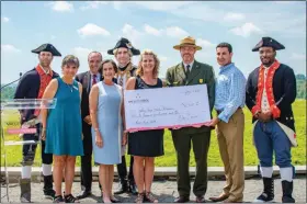  ?? SUBMITTED PHOTO ?? The Valley Forge Tourism and Convention Board recently presented a check for $56,500 to the national park — proceeds from this year’s annual Revolution­ary Run (Rev
Run). Historical reenactors join, from left to right, Rev Run Committee Member Barb Pollarine; Valley Forge Tourism and Convention Board President and CEO Mike Bowman; Montgomery County Commission­er Chairwoman Dr. Valerie Arkoosh; Rev Run Race Director Kirsten Tallman; Valley Forge National Historical Park Superinten­dent Steve Sims; and Montgomery County Commission­er Joseph C. Gale for the check presentati­on July 17.