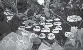  ??  ?? Stones bearing the names of the dead lie in the memorial garden at Marjory Stoneman Douglas High School in Parkland, Fla.