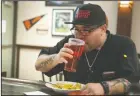  ??  ?? Above: Samuel Loya sips on a pink beer at Porter’s Pub in Downtown Lodi on Thursday. Left: A pink beer is seen at the Lodi restaurant.