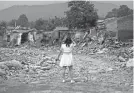  ?? NG HAN GUAN/AP FILE ?? A woman surveys damage after floodwater­s devastated her village on the outskirts of Beijing. Estimates say 3.9 million residents were affected by the floods in China.