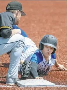  ??  ?? Canon-McMillan’s Noah Burke narrowly beats the tag from North Allegheny first baseman Anthony Hattrup.