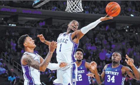  ?? Frank Franklin II The Associated Press ?? Duke’s Trevor Keels (1) fights for control of the ball as Kentucky’s Bates Jones (34) watches Tuesday during the first half of the Champions Classic at Madison Square Garden.