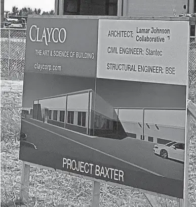  ?? RICHARD MIZE/THE OKLAHOMAN ?? A drawing of part of the Carvana reconditio­ning and inspection center under constructi­on at 5500 S. Rockwell Ave. is shown on a sign at the site.