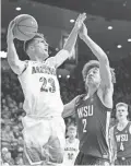  ?? CASEY SAPIO/USA TODAY SPORTS ?? Arizona guard Alex Barcello (23) shoots as Washington State forward CJ Elleby (2) defends on Saturday in Tucson.