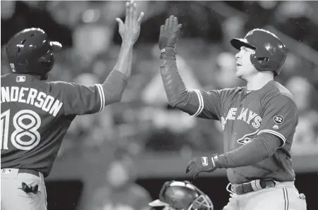  ?? NICK WASS, THE ASSOCIATED PRESS ?? Blue Jays outfielder Steve Pearce, right, celebrates his two-run homer with Curtis Granderson during the third inning against the Orioles on Monday in Baltimore. Pearce has now homered in three straight games.