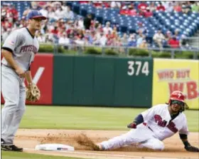  ?? CHRIS SZAGOLA — THE ASSOCIATED PRESS ?? Philadelph­ia Phillies’ Freddy Galvis, right, steals third base as Pittsburgh Pirates third baseman David Freese, left, looks on during the first inning of a baseball game, Tuesday in Philadelph­ia.
