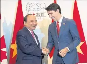  ?? JACQUES BOISSINOT — THE CANADIAN PRESS VIA AP ?? Prime Minister Justin Trudeau, right, meets with the Prime Minister of Vietnam, Nguyen Xuan Phuc, during a bilateral meeting as part of the G7, Sunday in Quebec City.